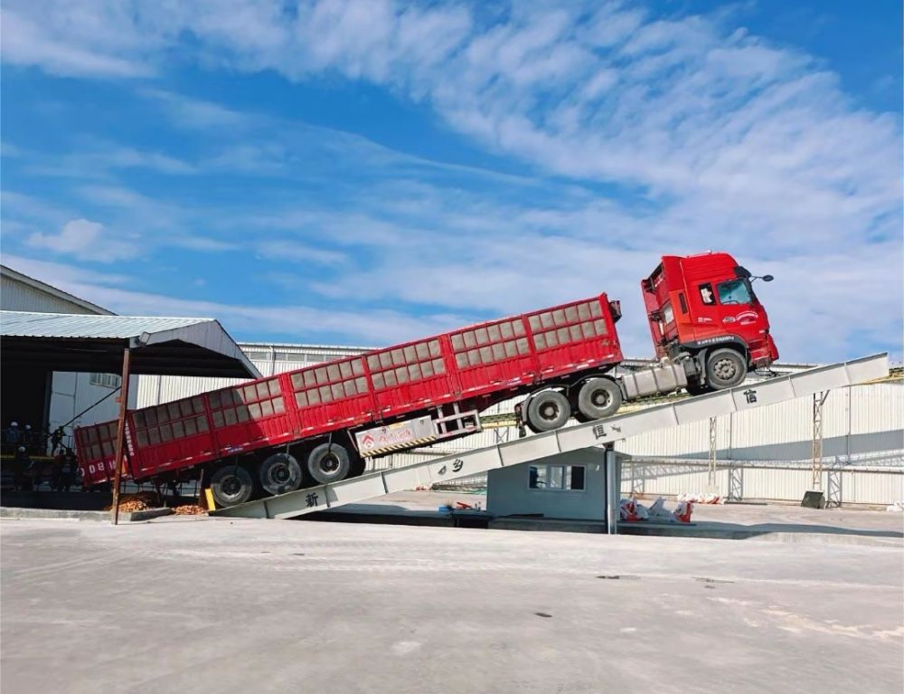 液壓卸車機、后翻式液壓翻板卸車平臺、河南愛信液壓翻板機